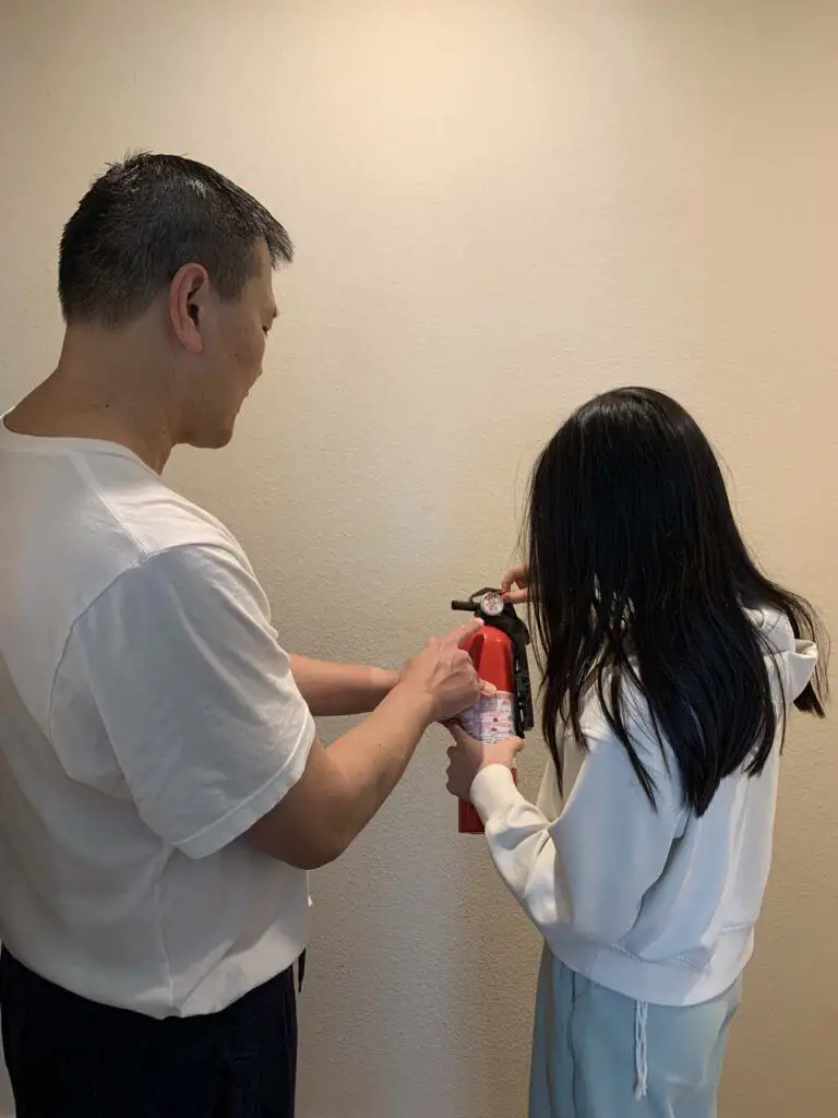 Teaching our daughter how to use the fire extinguisher