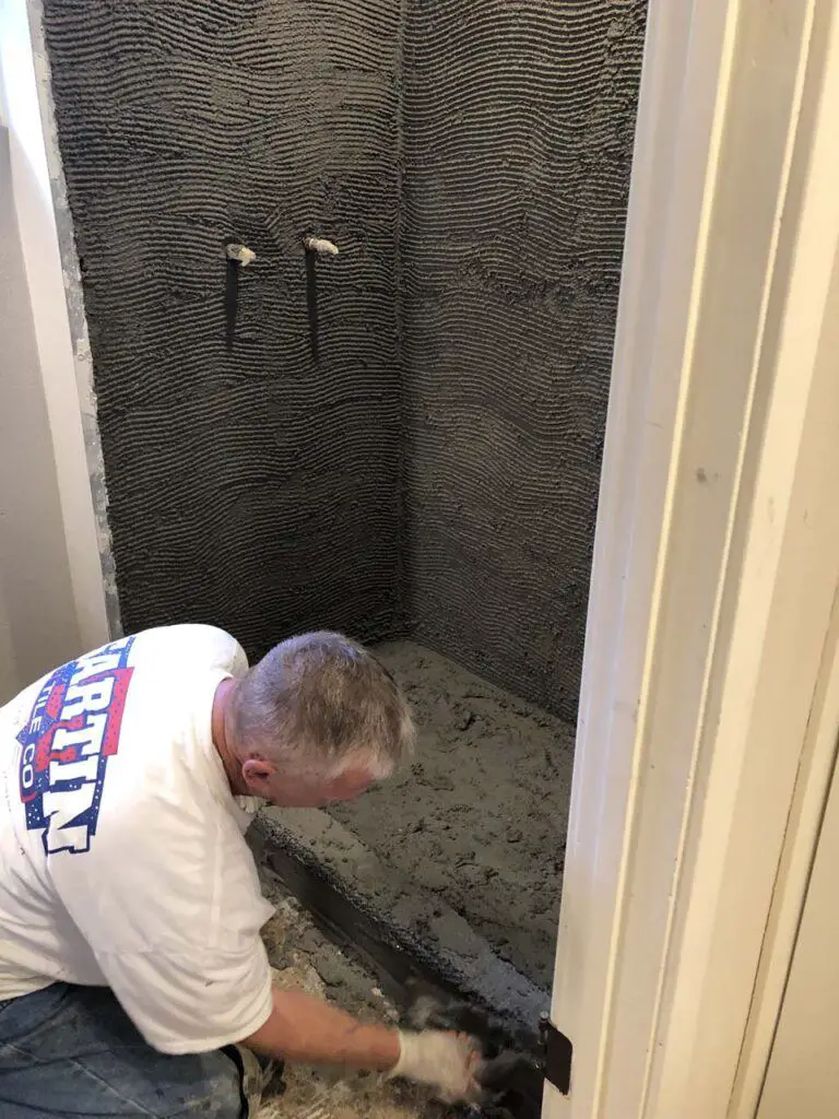 Our tile contractor mudding up the shower curb while working on the shower pan