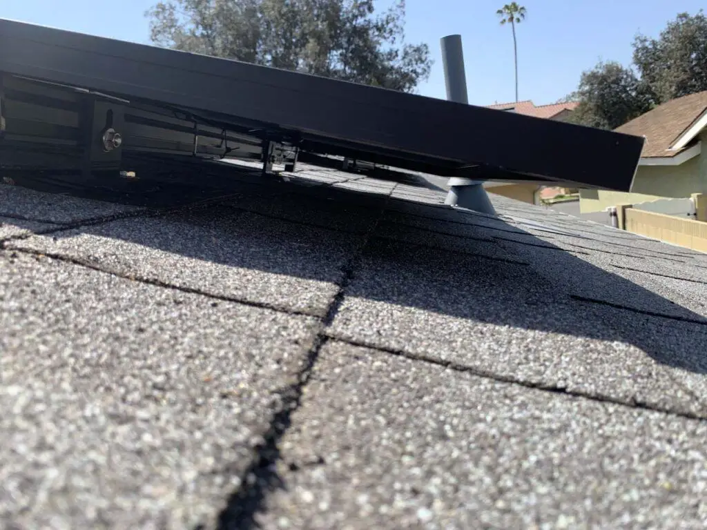 Looking underneath our solar PV array at the mounting racks, which must be installed correctly or else we would be getting costly leaks through the roof