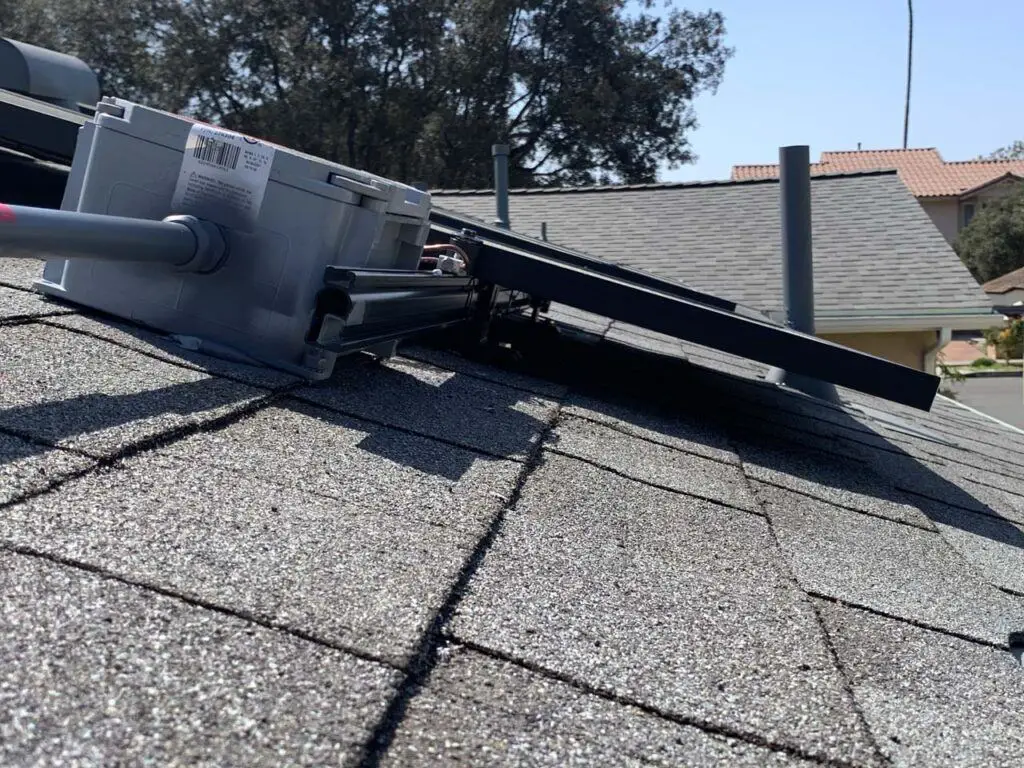 Closer look at the supports holding up the solar panels, where the installation of the supports shouldn’t be causing a leak in the roof nor voiding the warranty (especially since it was the same company that installed both)