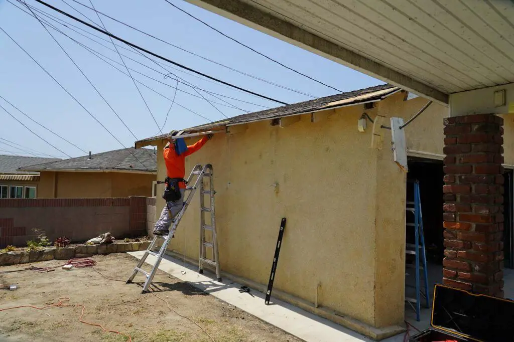 Kenny inserting a new rafter into the garage to replace one that was compromised by shoddy repairs by a prior termite company