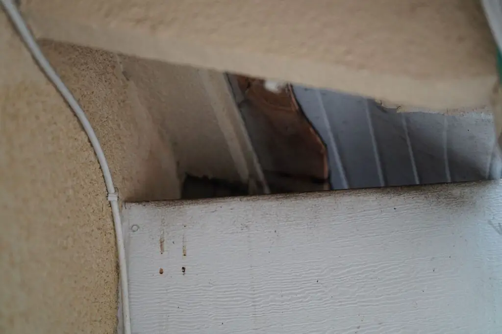 Note the dark area on the top of this beam.  That's where the rats would climb up onto the patio, rub the top of the beam (hence the dark area), and then scurry underneath the flashings to gain access to the attic. 