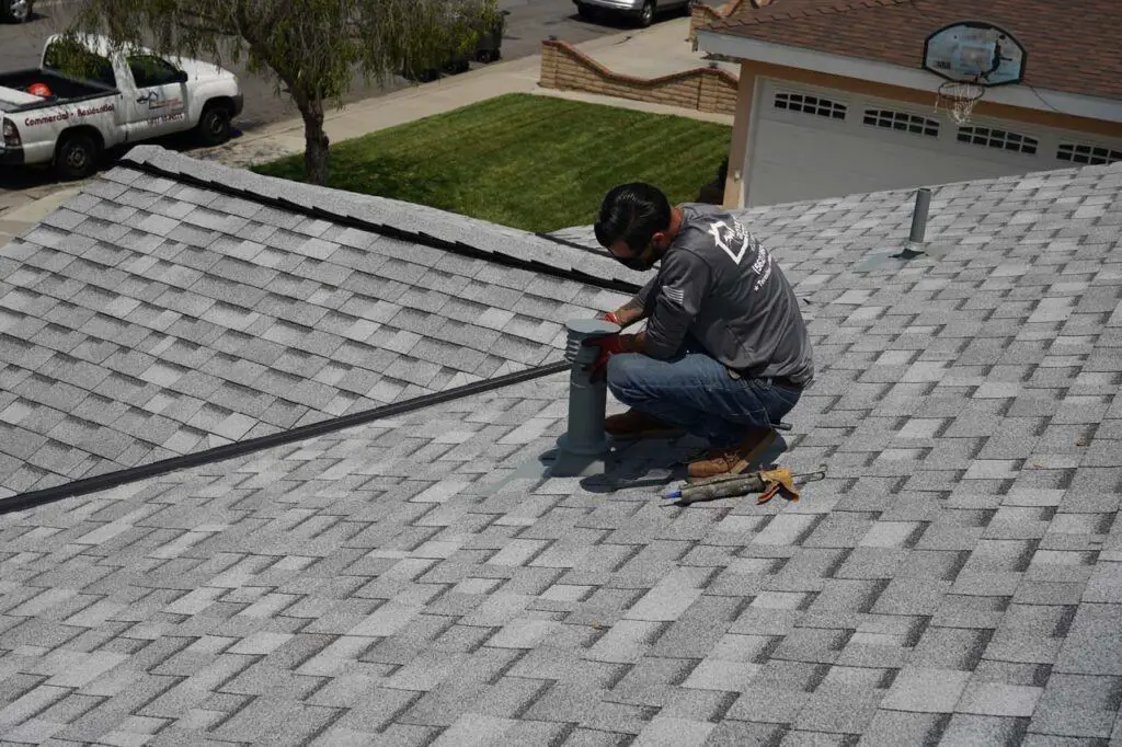 The pest control person putting adhesives to hold the metal nets designed to keep rodents out of the attic