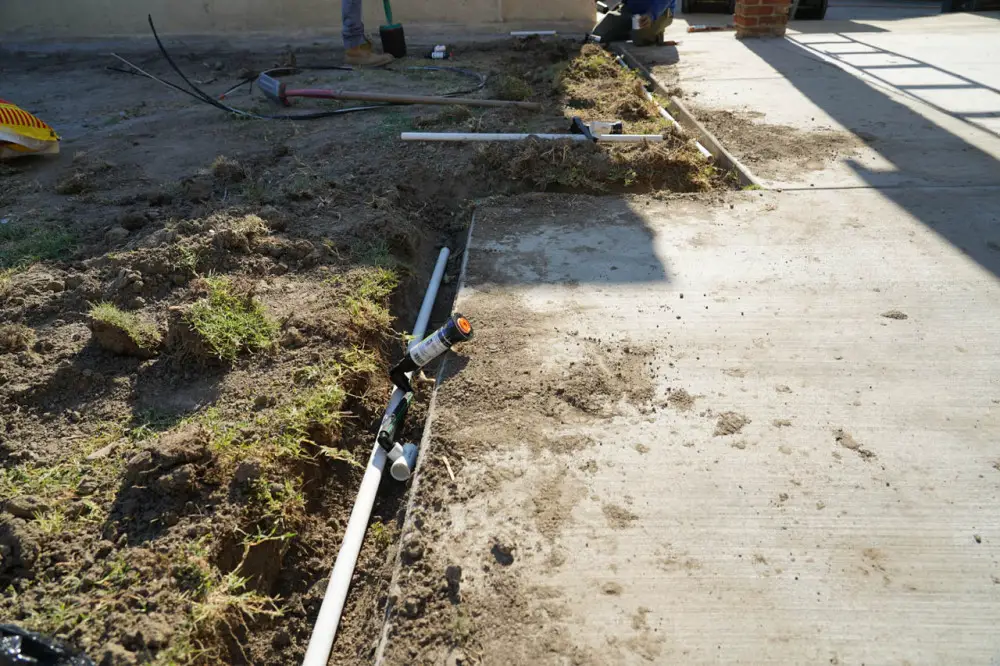 Sprinkler system being reinstalled in the backyard