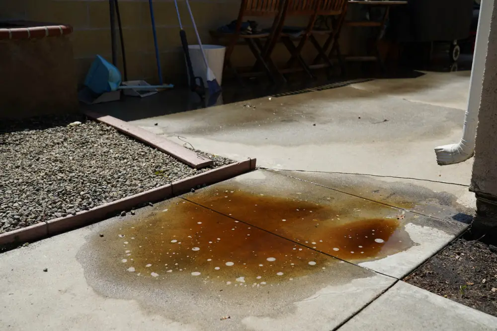 This rust-colored puddle is a sign that we need a drain there or else risk having that concrete dissolve over time