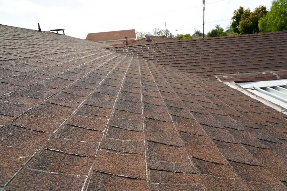 You know an old roof is in need of replacement when the shingles are worn down to the whites of the fiberglass